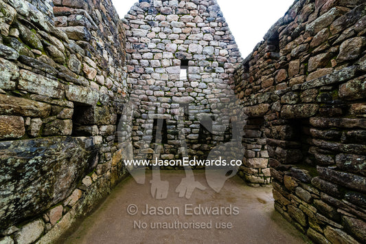 A window in a trapezoidal wall in a residential building at Macchu Picchu. Peru.