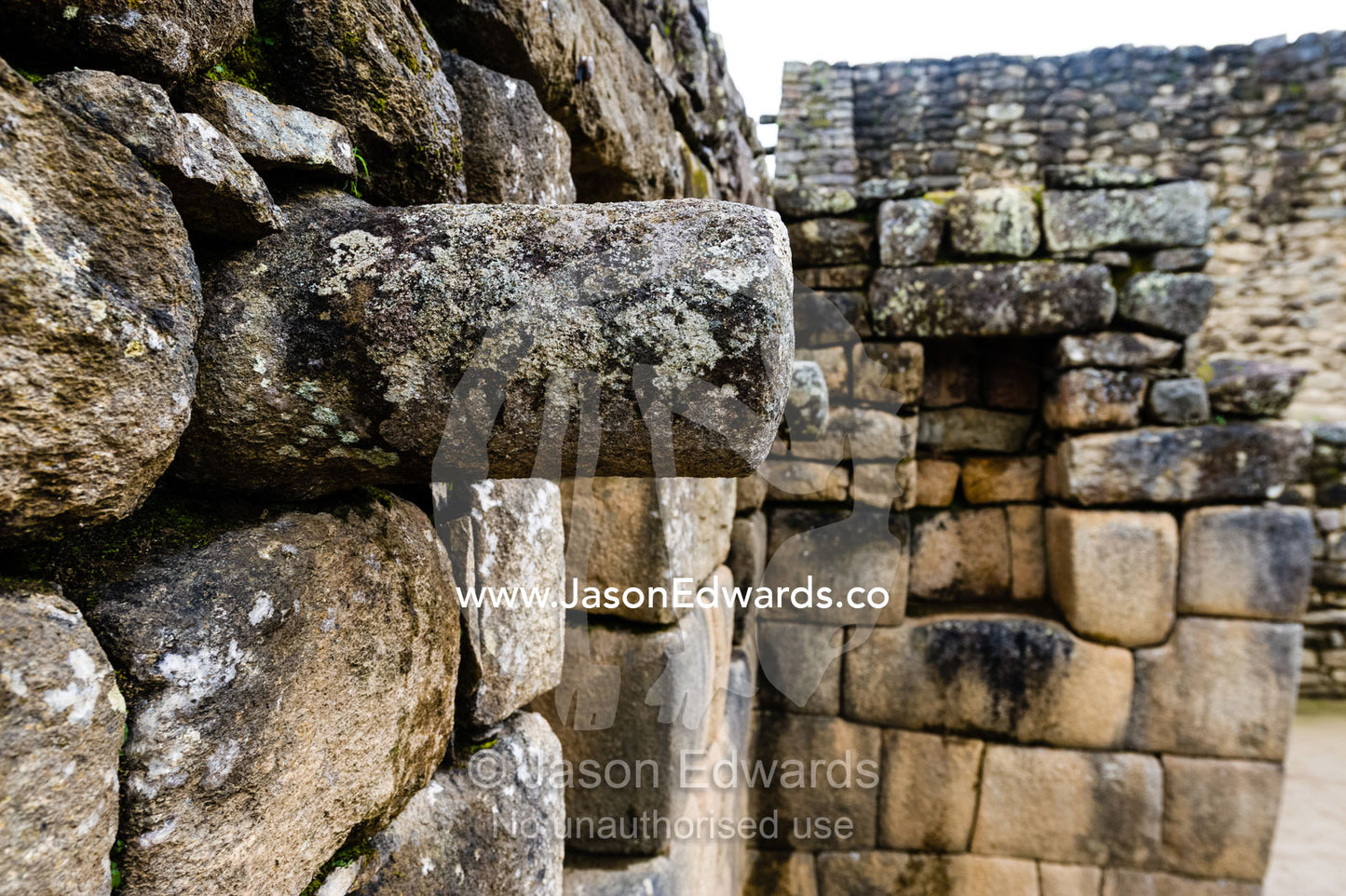 A stone joist emerges from a wall to support a ceiling in a Inca building. Peru.