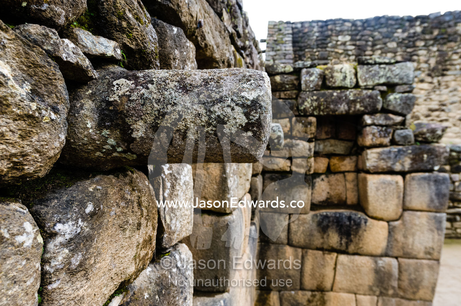 A stone joist emerges from a wall to support a ceiling in a Inca building. Peru.