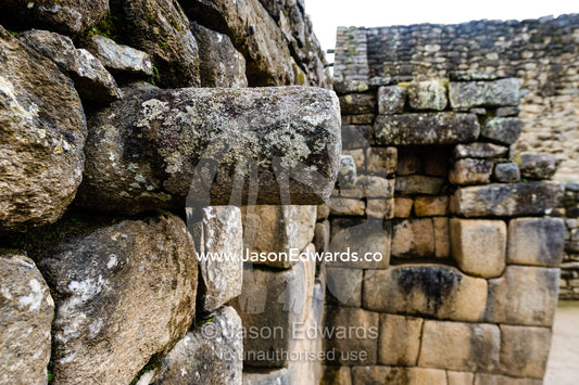 A stone joist emerges from a wall to support a ceiling in a Inca building. Peru.