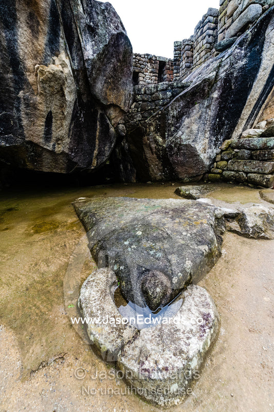 The Temple of the Condor with a carving of an Andean Condor head and an alter in a natural cave. Peru.