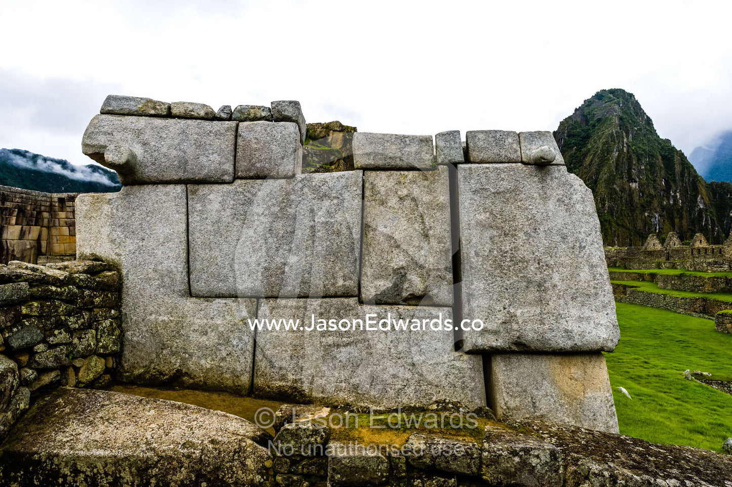 Large rocks shaped to fit a geometric Inca dry-stone wall in the ruins at Macchu Picchu. Peru.