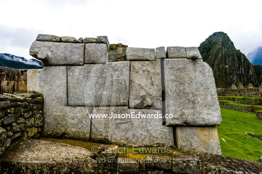 Large rocks shaped to fit a geometric Inca dry-stone wall in the ruins at Macchu Picchu. Peru.