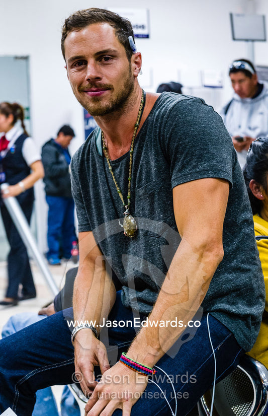 People waiting to board planes in an airport. Cusco, Peru.