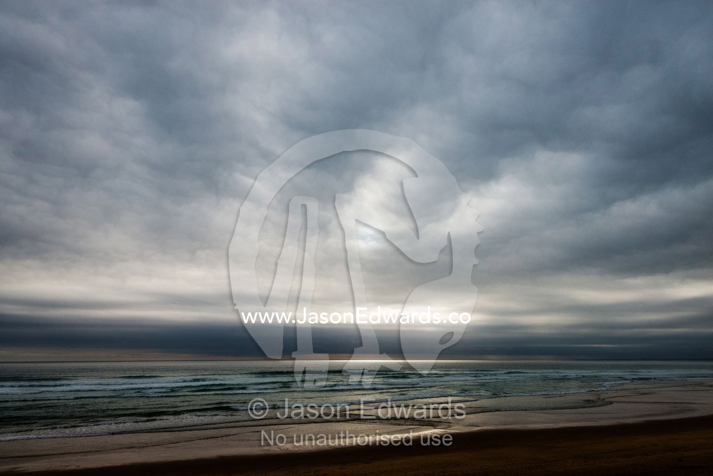Grey clouds hang over a deserted beach on a stormy day. Victoria, Australia.