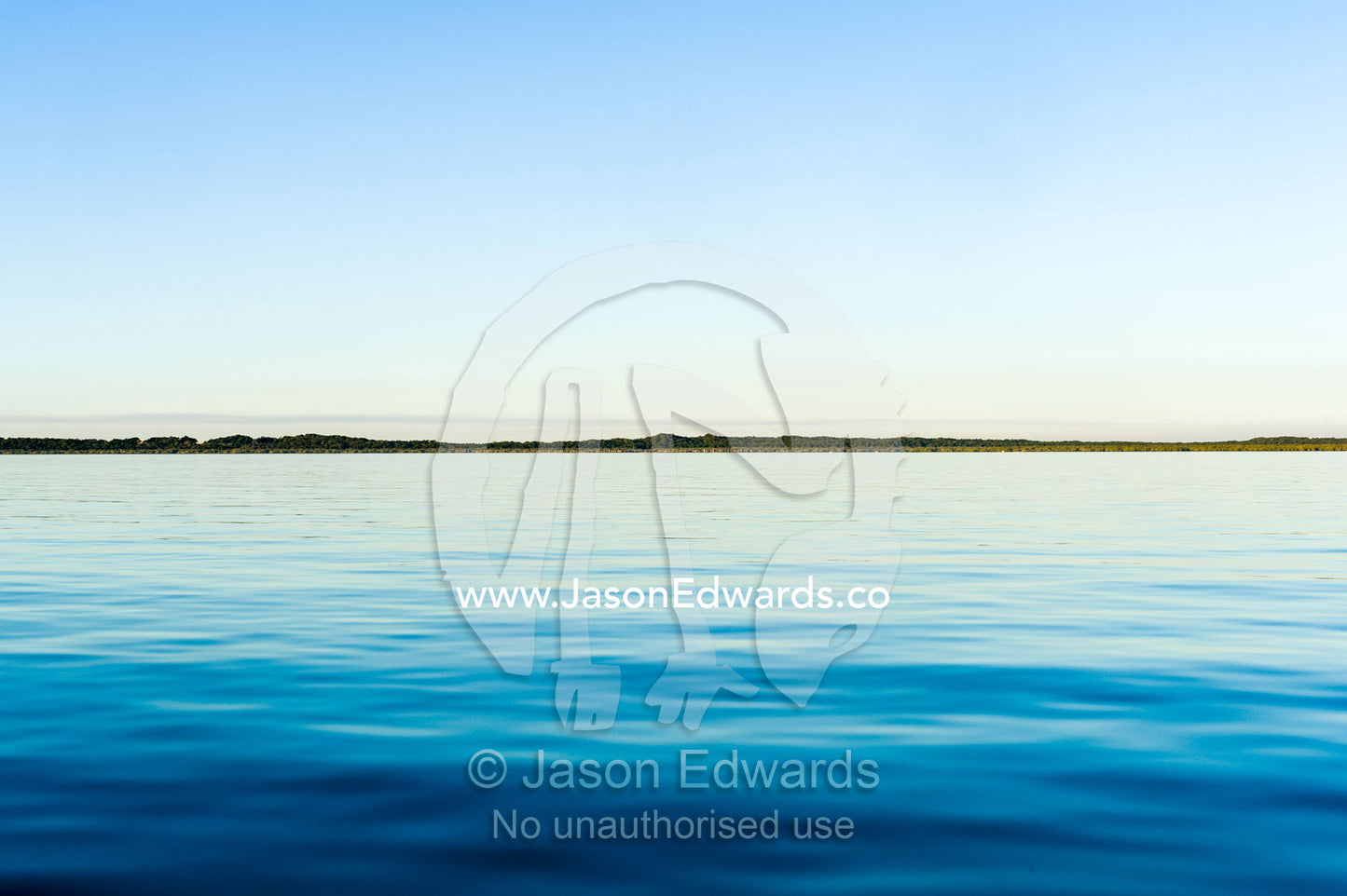 A dead calm ocean surface at twilight. Queensland, Australia.