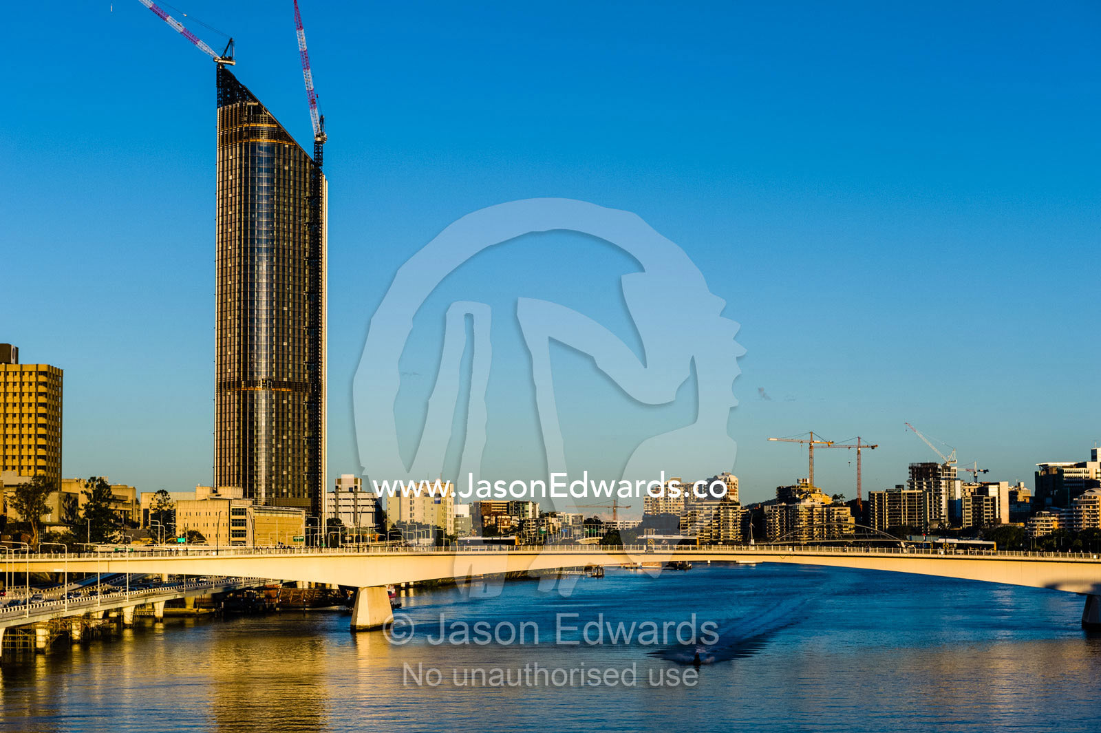 A jet ski speeds beneath a bridge in the central business district. Brisbane, Queensland, Australia.