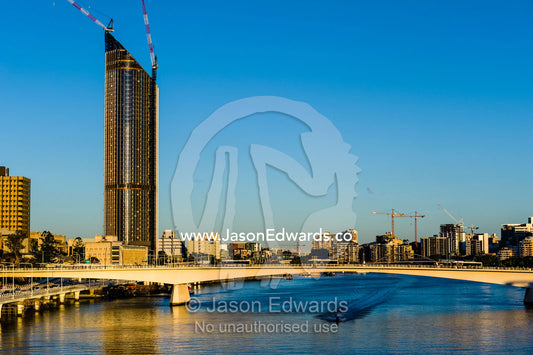 A jet ski speeds beneath a bridge in the central business district. Brisbane, Queensland, Australia.