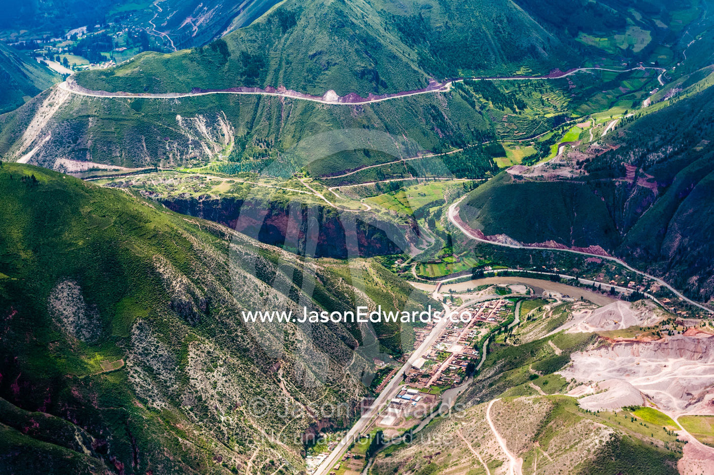 Deforestation where roads are carved into an Andes mountain valley. Cusco, Peru.