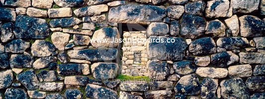 A window in a trapezoidal wall in a residential building at Macchu Picchu. Peru.