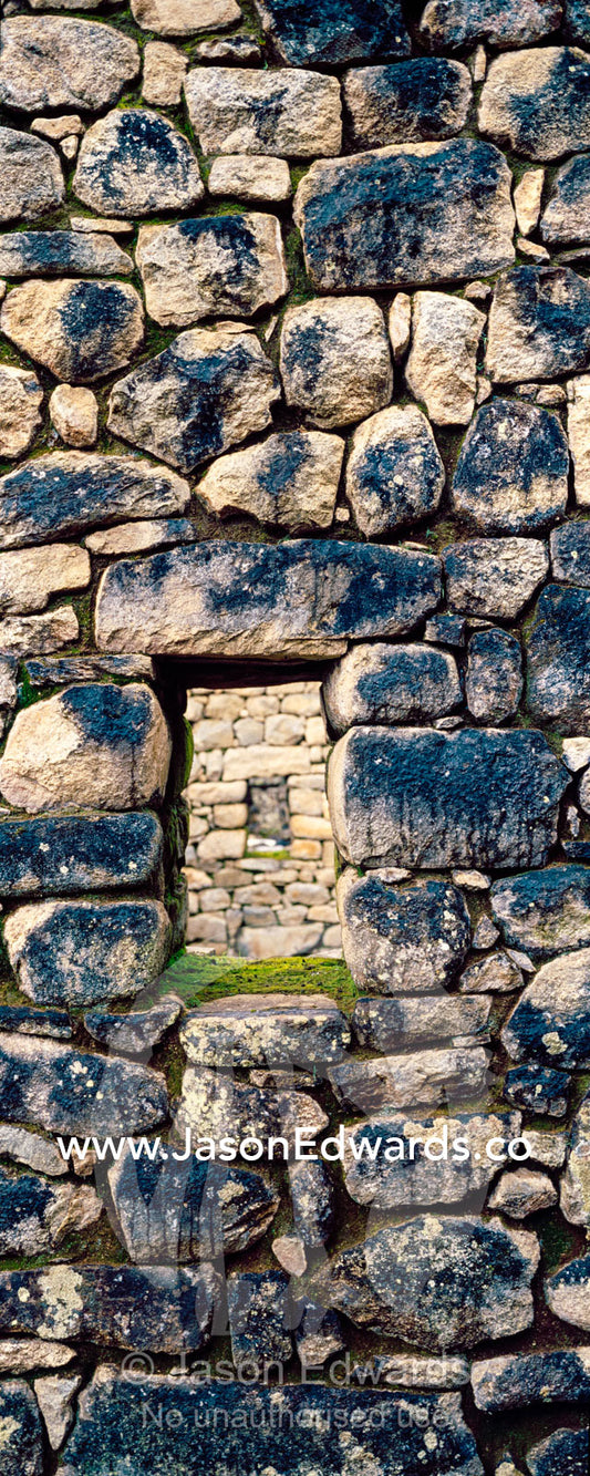A window in a trapezoidal wall in a residential building at Macchu Picchu. Peru.