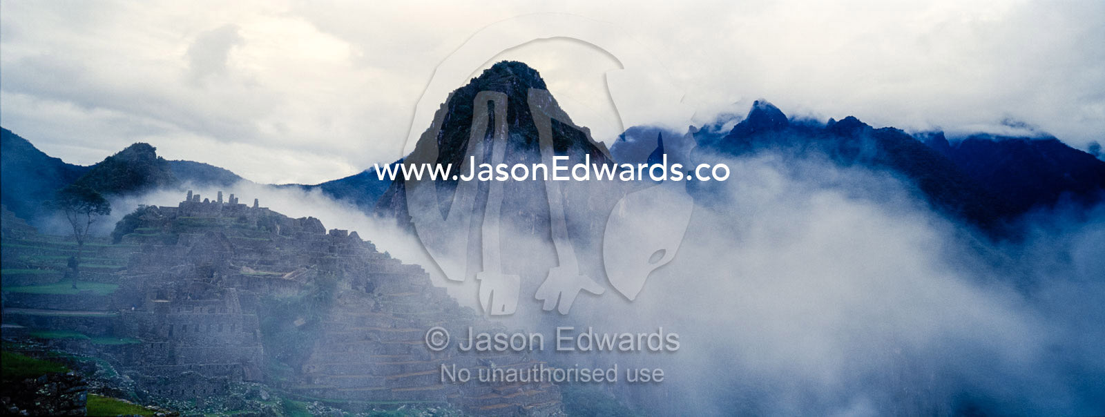 Clouds and mist engulf the ruins of Macchu Picchu in the Andes mountains. Peru.