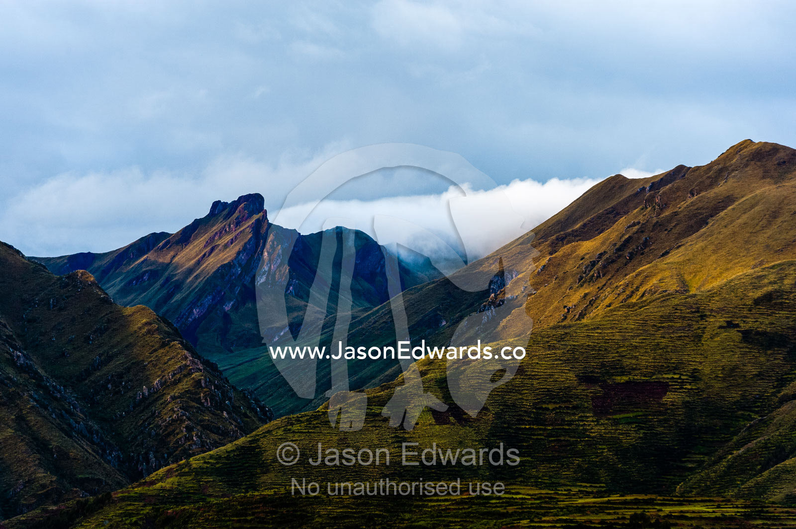 Pastel hues colour the flanks and summit of the Andes mountains. Peru.