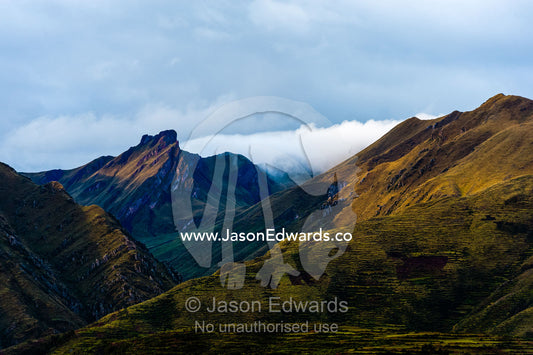 Pastel hues colour the flanks and summit of the Andes mountains. Peru.