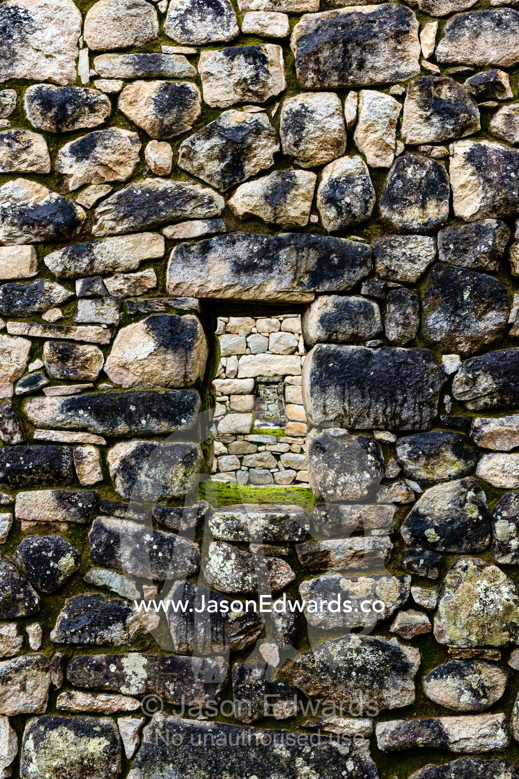 A window in a trapezoidal wall in a residential building at Macchu Picchu. Peru.