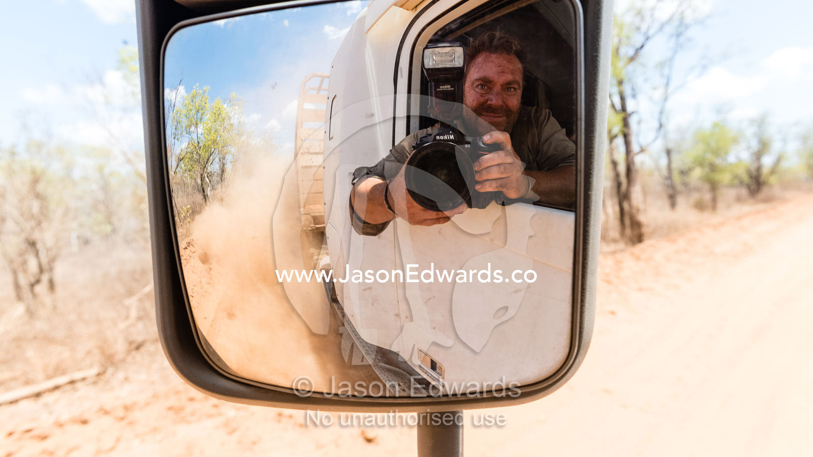 Self-portrait of photographer Jason Edwards riding in a truck on a remote cattle station. Bullo River Station, Northern Territory, Australia