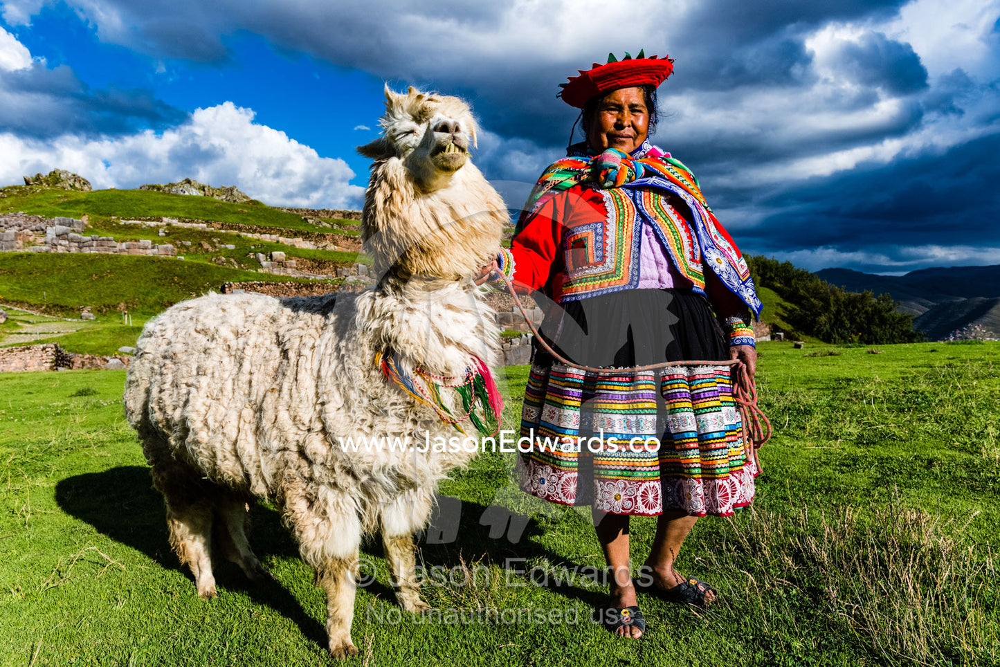 A Quechua woman poses in traditional dress with her Llama. Cusco, Sacsayhuaman, Cusco Region, Peru