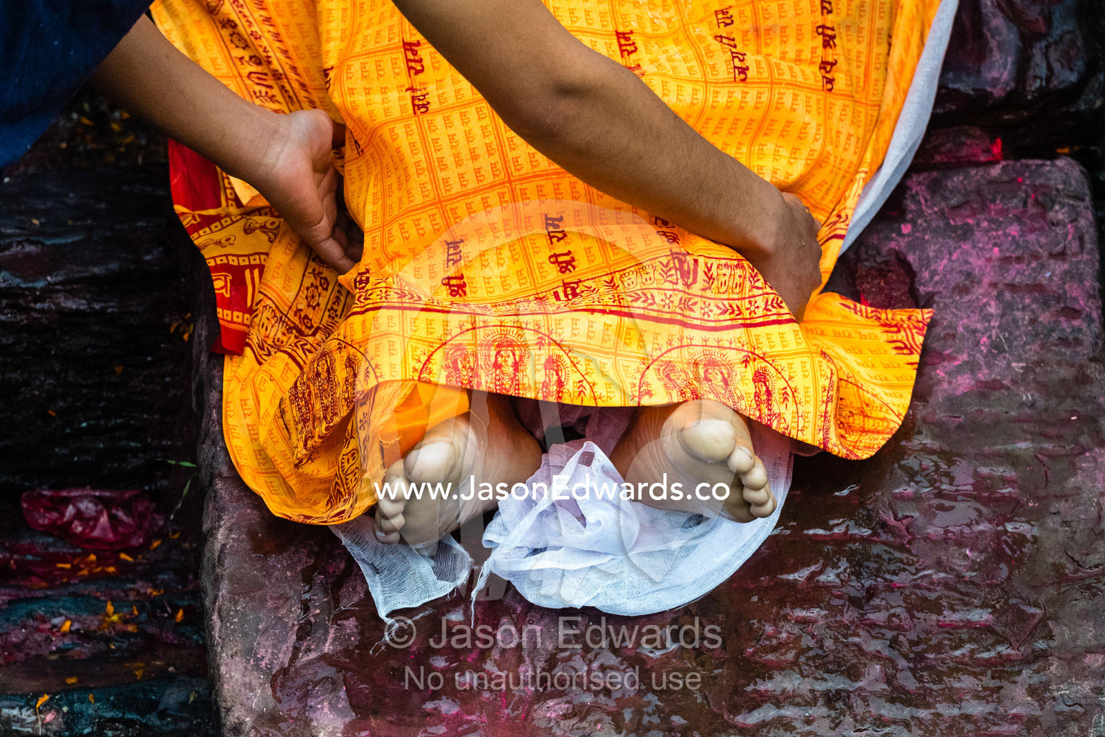 At a Hindu temple by a holy river family and friends offer prayers and offerings to a family member during a cremation. Kathmandu, Pashupatinath Temple, Nepal
