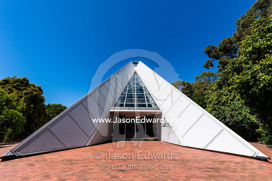 The triangular geometric lines of a steel and glass conservatory greenhouse. Adelaide, Bicentennial Conservatory, Adela, South Australia, Australia