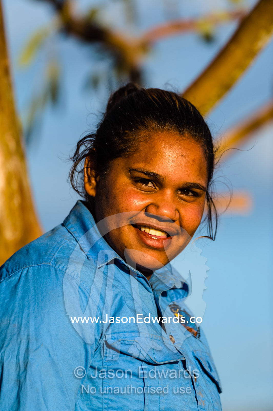 An aboriginal student learns about rescued wild horses known as a brumby's on an outback station. Namatjira, Ipolera Out Station, Northern Territory, Australia