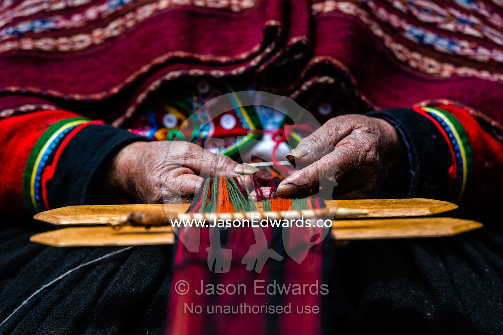 The weathered and hardened hands of an elderly Quechua woman weaving Llama wool. Chinchero, Chinchero District, Urubamba Province, Peru
