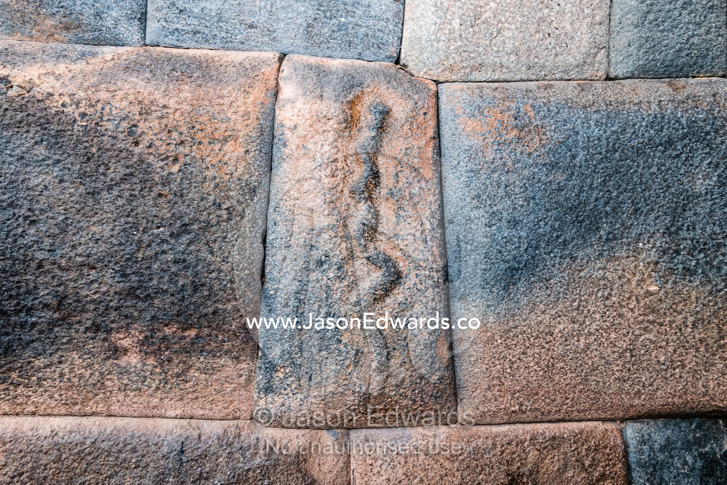 A snake motif carved onto an Inca stone block. Cusco, Cusco Region, Peru