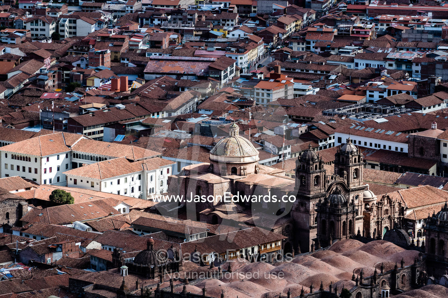 An aerial view of the Templo de la Compana de Jesus and Cusco terracotta rooftops. Cusco, Cusco Region, Peru