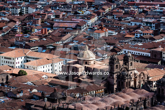 An aerial view of the Templo de la Compana de Jesus and Cusco terracotta rooftops. Cusco, Cusco Region, Peru