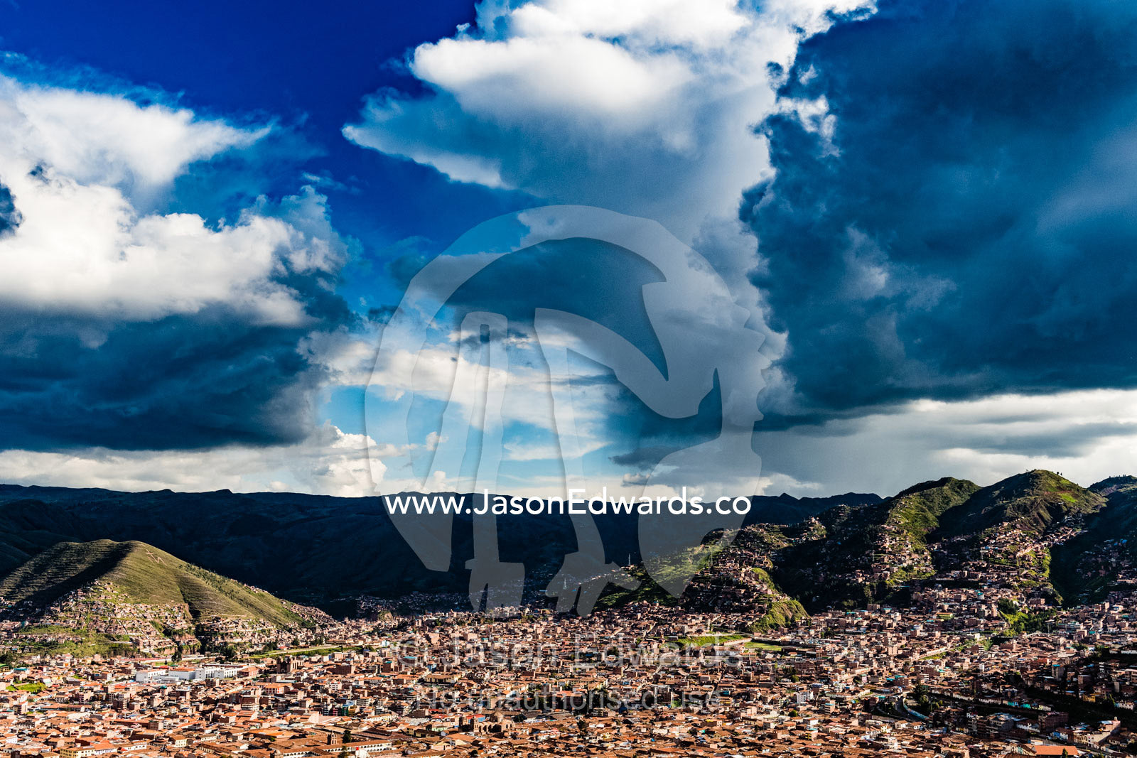 Ominous storm clouds gather over the Andes and terracotta rooftops of Cusco. Cusco, Cusco Region, Peru