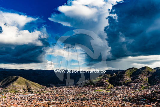 Ominous storm clouds gather over the Andes and terracotta rooftops of Cusco. Cusco, Cusco Region, Peru