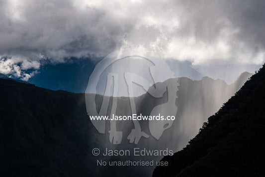 Sheets of rain descend between valleys in the Andes Mountains. Sacred Valley, Machu Picchu, Urubamba Province, Peru