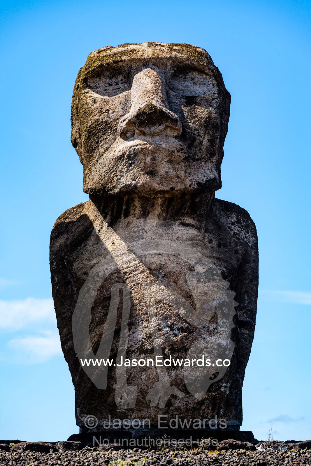 The weathered stone face of an ancient Moai statue representing a human figure. Ahu Tongariki, Rapa Nui, Easter Island, Chile