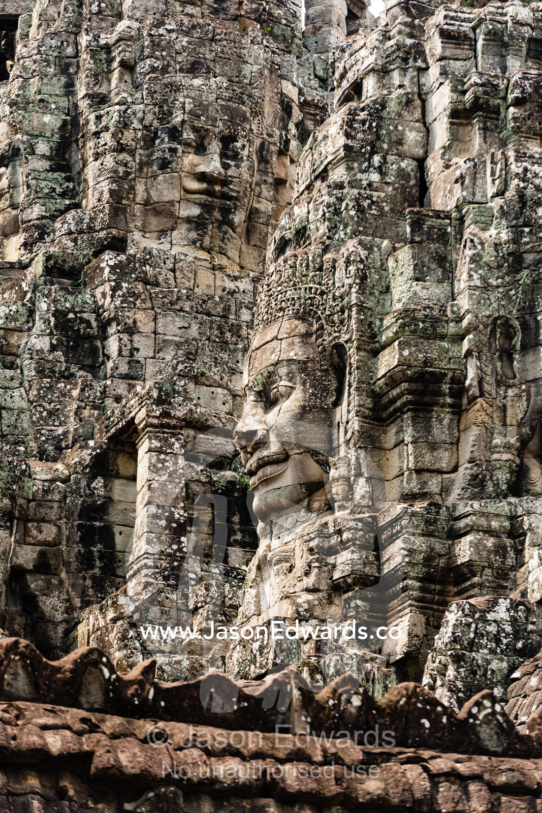 Intricate stone temple galleries supporting Buddhist face-towers. Siem Reap, Angkor Wat, Ta Prohm, Bayon Temp, Cambodia