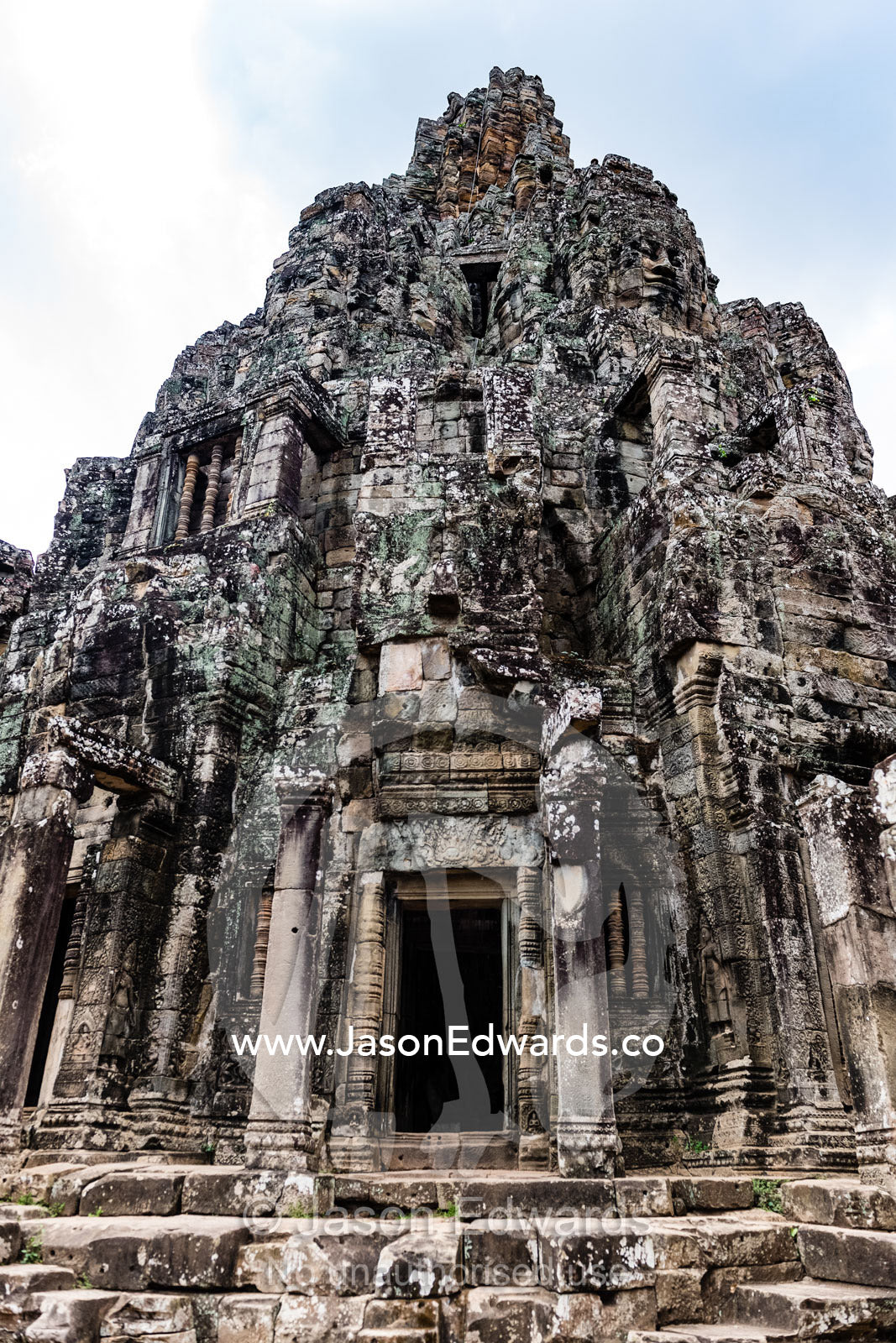 Intricate stone temple galleries supporting Buddhist face-towers. Siem Reap, Angkor Wat, Ta Prohm, Bayon Temp, Cambodia
