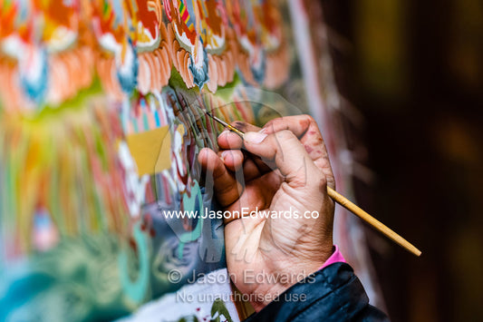 An artist hand painting a thangka, a Tibetan Buddhist scroll painting. Kathmandu, Bhaktapur, Nepal