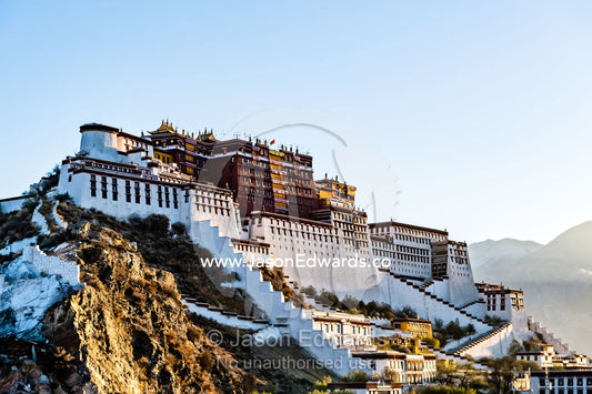 The towering facade, shield wall and bastions of the Potala Palace overlooking the Himalaya at dawn. Lhasa, Tibet Autonomous Region, Tibet