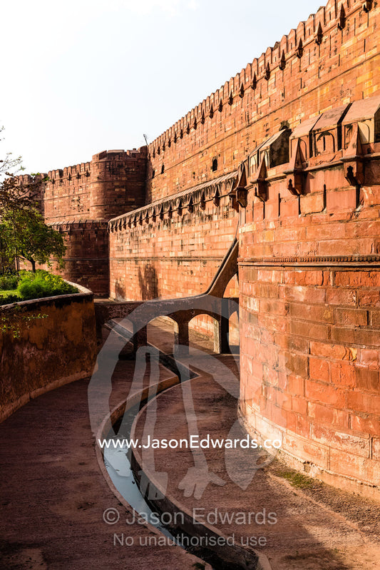 The towering shield wall and wide moat of the Mughal Dynasty Agra Fort. Agra, Agra Fort, Uttar Pradesh, India