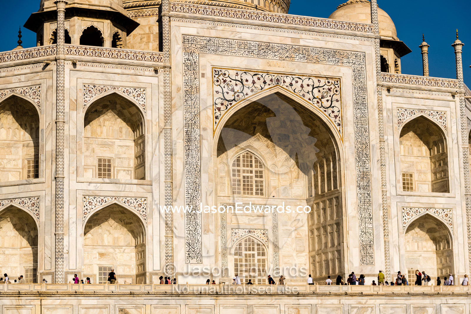 Large vaulted marble iwans with pietra dura inlay topped by guldasta in the facade of the Taj Mahal. Agra, Taj Mahal, Uttar Pradesh, India