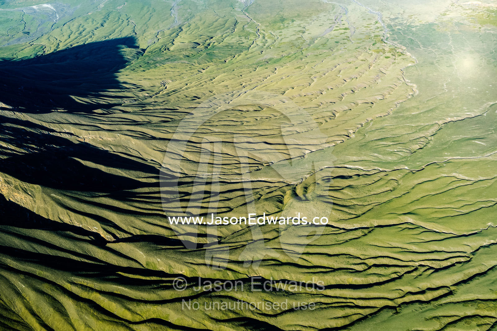 Lava flows and erosion on the slopes of a volcano caldera in the Great Rift Valley. Serengeti National Park, Oldonyo Lengai, Tanzania