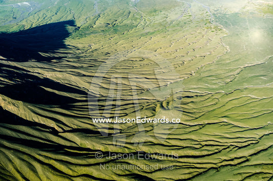 Lava flows and erosion on the slopes of a volcano caldera in the Great Rift Valley. Serengeti National Park, Oldonyo Lengai, Tanzania