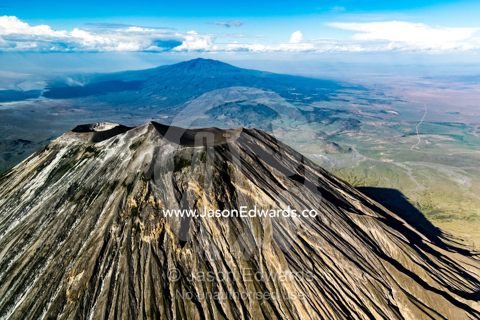 Sweeping lava flows and erosion on the slopes of a volcano caldera cone in the Great Rift Valley. Serengeti National Park, Oldonyo Lengai, Tanzania