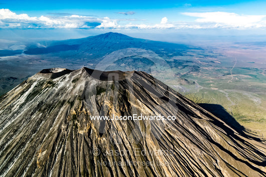 Sweeping lava flows and erosion on the slopes of a volcano caldera cone in the Great Rift Valley. Serengeti National Park, Oldonyo Lengai, Tanzania