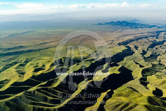 Sweeping lava flows and erosion on the slopes of a volcano caldera in the Great Rift Valley. Serengeti National Park, Oldonyo Lengai, Tanzania