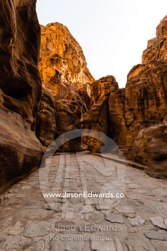 A view of the Siq gorge the main entrance to Petra, showing Roman paving stones. Petra, The Lost City of Petra, Jordan