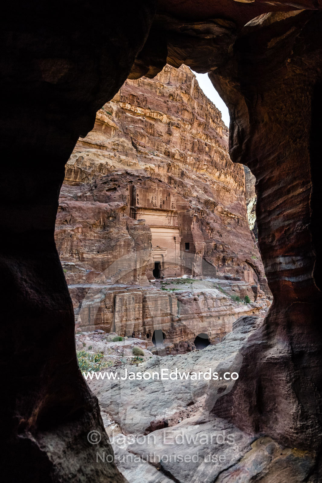 Ancient Nabatean tombs carved into a cliff face from inside another tomb. Petra, The Lost City of Petra, Jordan