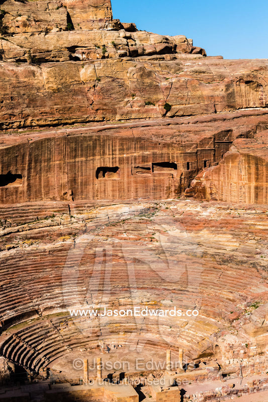 A bird's-eye view of the rock-cut Theatre carved into a cliff and stone seats. Petra, The Lost City of Petra, Jordan