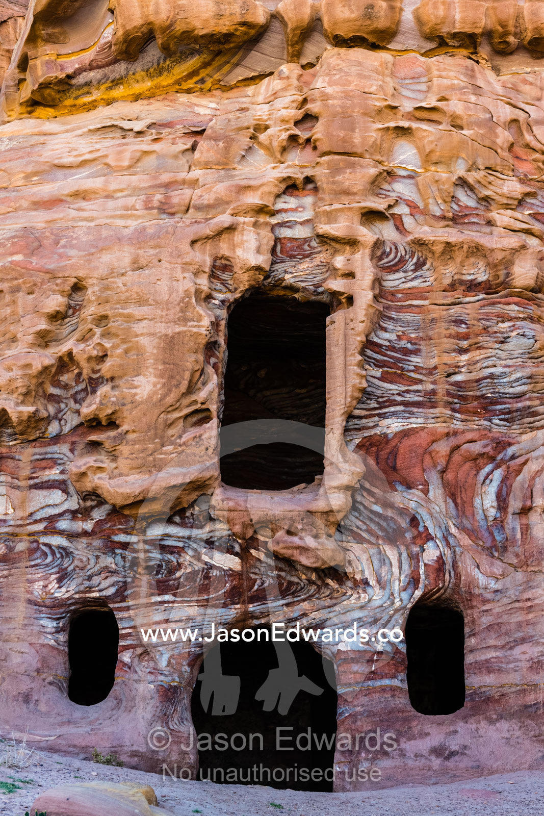 Unidentified rock-cut tomb near the Street of Facades, featuring dramatic coloration of sandstone matrix. Petra, The Lost City of Petra, Jordan
