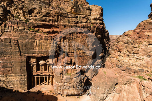 The rock-cut facade of The Treasury tomb showing the enormous columns in a sandstone gorge. Petra, The Lost City of Petra, Jordan