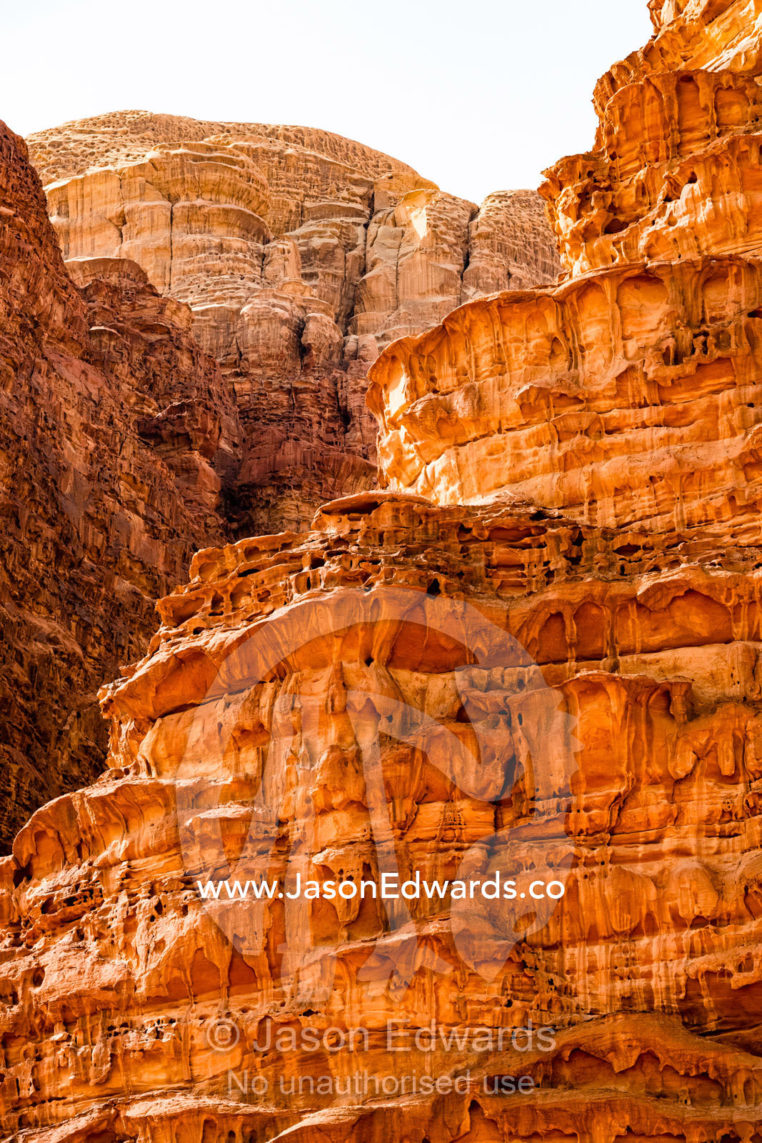 Sunlight illuminates a sandstone cliff. Wadi Rum, The Valley of the Moon, Jordan