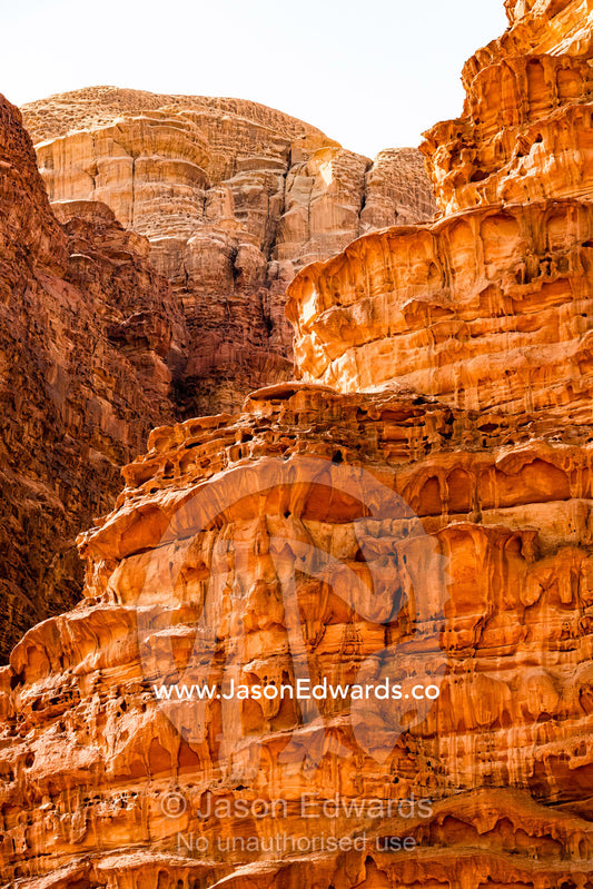 Sunlight illuminates a sandstone cliff. Wadi Rum, The Valley of the Moon, Jordan